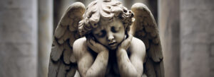 Sad stone cherub angel statue with folded wings, symbolizing grief, loss, and heartfelt sorrow.