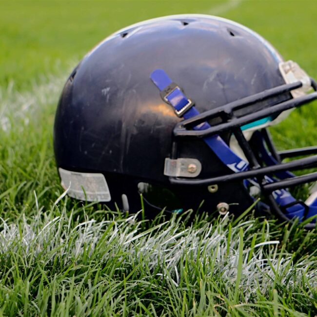 football-helmet-resting-on-football-field-yard