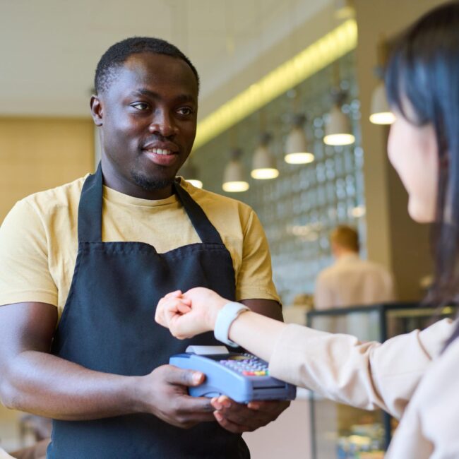girl paying with her smartwatch