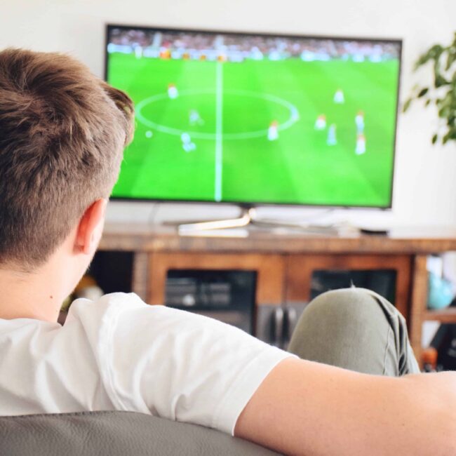 young-man-watching-soccer-game-on-tv-football-game