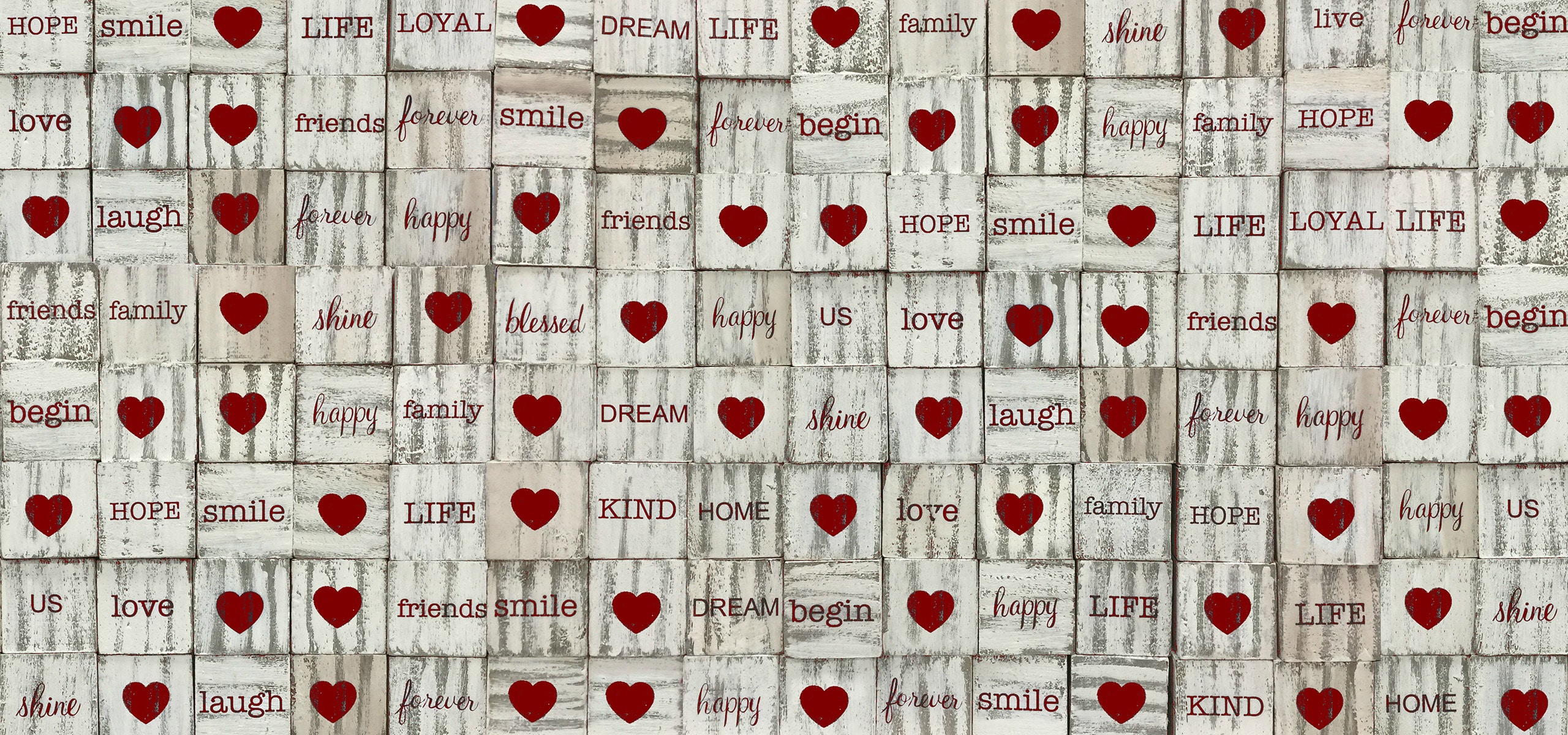 Rustic wooden background with red hearts and uplifting words for love and happiness themes.